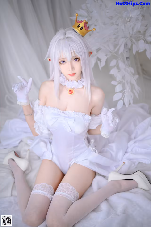 A woman in a white dress with a crown on her head.