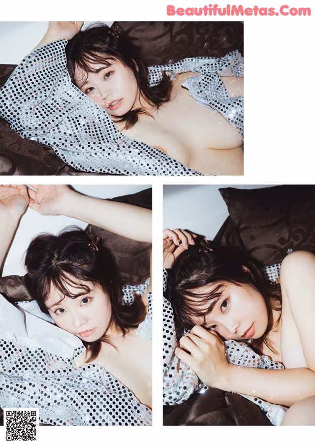 A woman laying on top of a bed covered in a blanket.