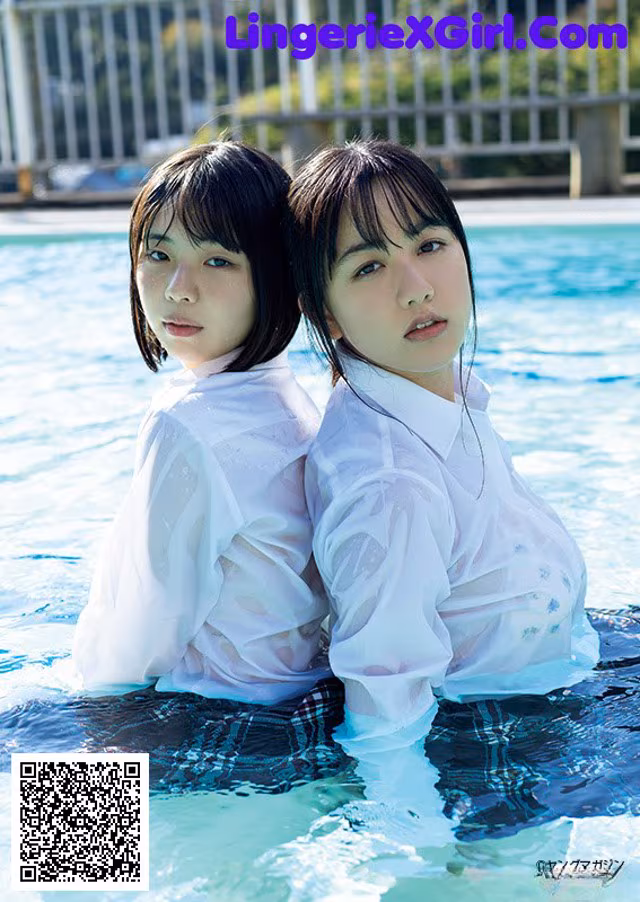 A couple of young women sitting in a swimming pool.