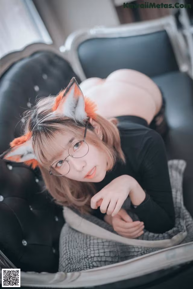 A woman wearing glasses and a fox ears headband.
