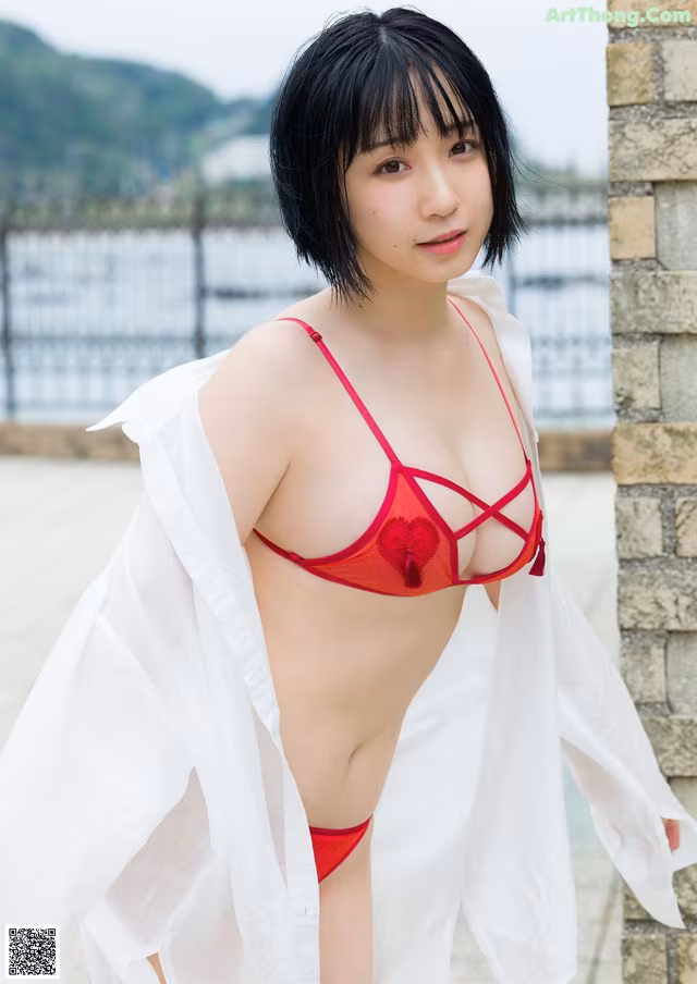 A woman in a red bikini posing for a picture.