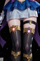 A woman in a sailor outfit with a purple cape and thigh high stockings.